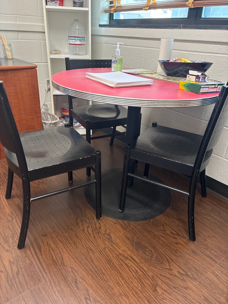 Round Red Top Table with Black Chairs
