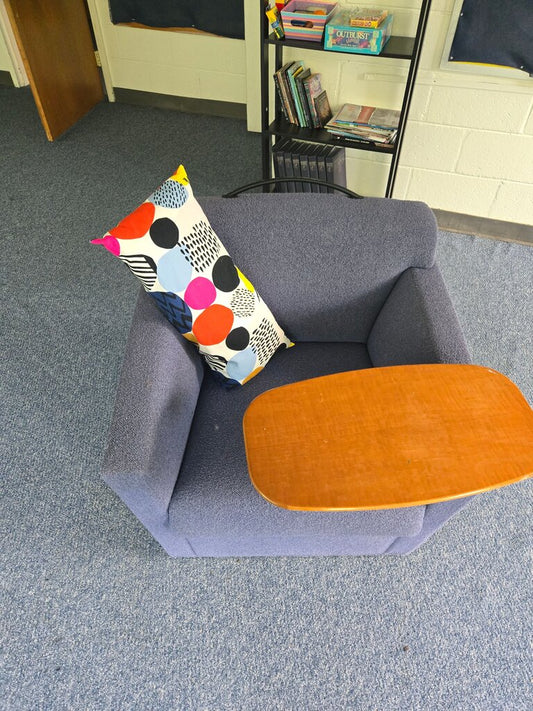 Cozy Blue Armchair with Side Table and Colorful Pillow