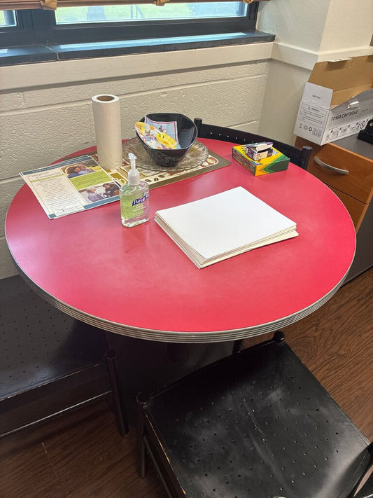 Round Red Top Table with Black Chairs